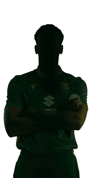 Silhouetted athlete in a green jersey with arms crossed, holding a ball against the chest.