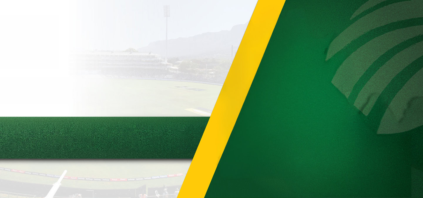 Abstract stadium banner with green and yellow diagonal shapes; blurred stands and field visible in the background.